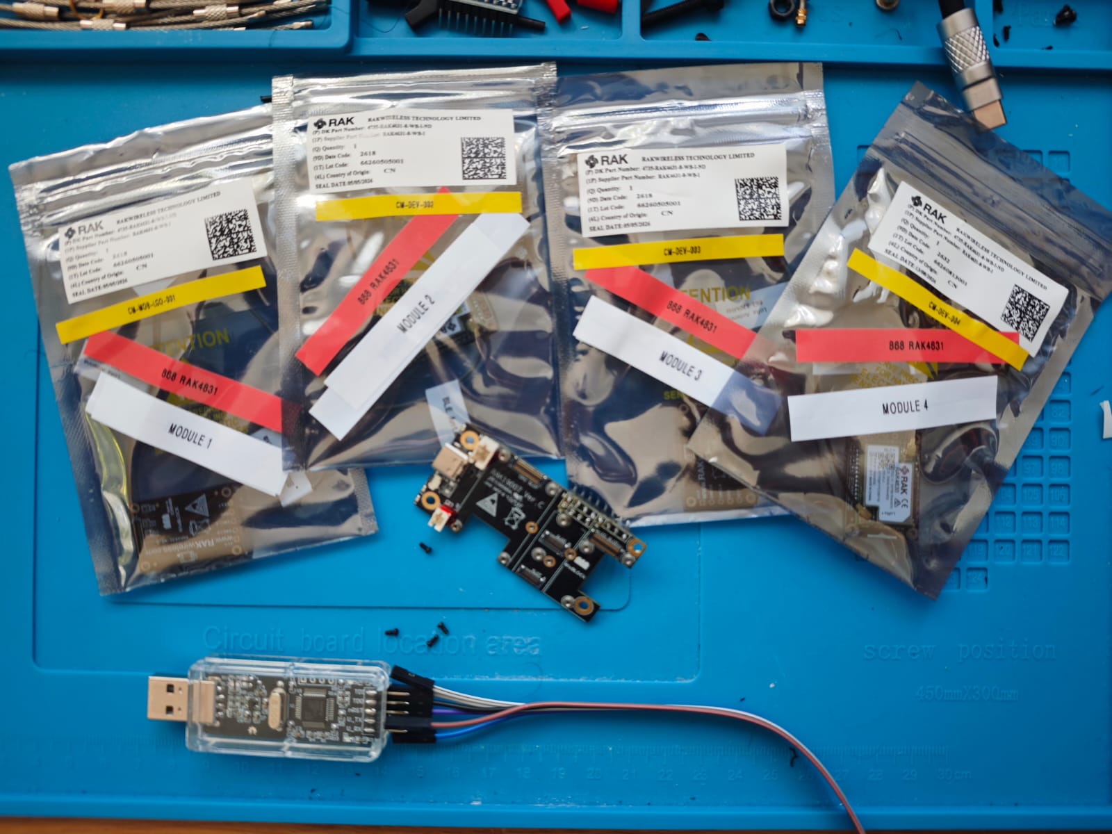 CRUX RAK4631 modules and RAKDAP1 programmer on an electronics workbench during the October recovery campaign